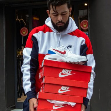 Man Carrying Stack of Shoe Boxes