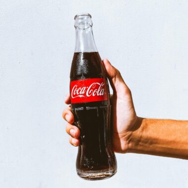 Man Holding a Cold Coca-Cola in a Glass Bottle 